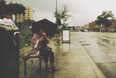 Full length of woman standing by railing