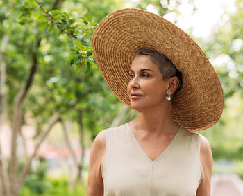 Portrait of woman wearing hat standing outdoors