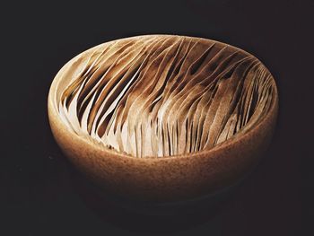 Close-up of patterned bowl over black background