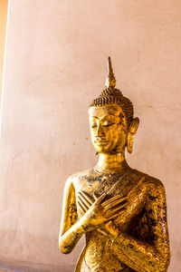 Statue of buddha against wall