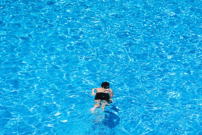 High angle view of woman swimming in pool