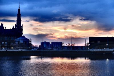 City at waterfront during sunset