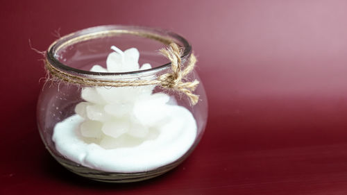 Close-up of ice cream in glass jar on table