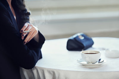 Midsection of woman using mobile phone