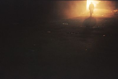 Silhouette people standing on street at night