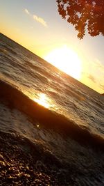 Scenic view of beach against sky during sunset