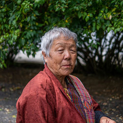 Portrait of woman against plants