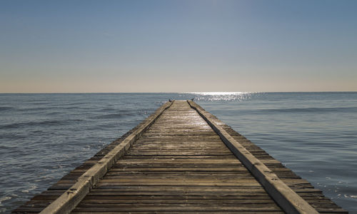 Pier over sea against clear sky