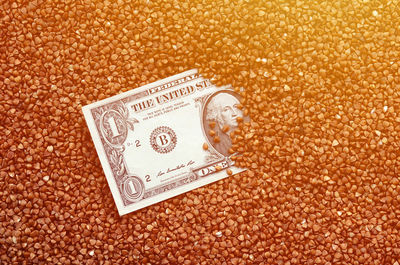 High angle view of paper currency on buckwheat