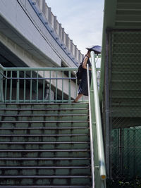Woman walking on steps in city