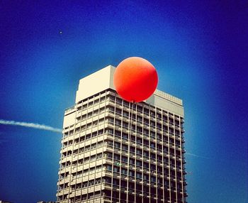 Low angle view of modern building against blue sky