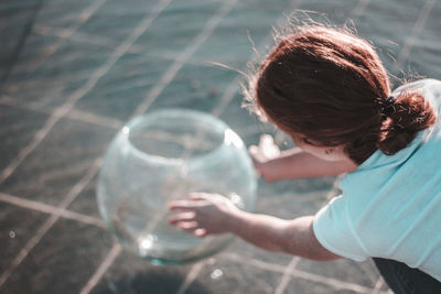 Rear view of woman with bubbles in water