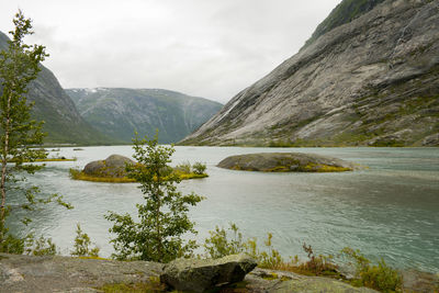 Scenic view of lake and mountains against sky