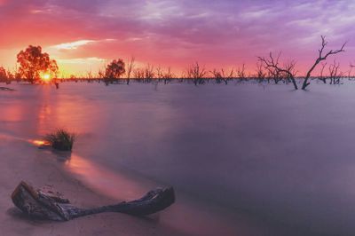 Scenic view of lake against sky during sunset