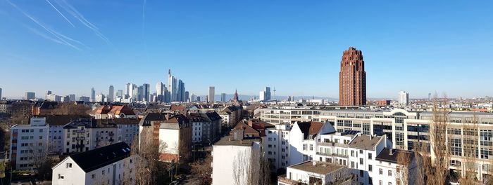 Modern buildings in city against clear sky