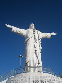 Low angle view of statue against blue sky