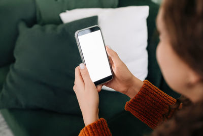 Midsection of woman using mobile phone