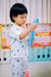Portrait of cute boy playing with toys
