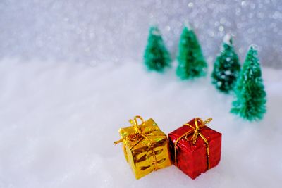 Close-up of small christmas presents on fake snow