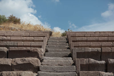 Low angle view of stone steps against sky