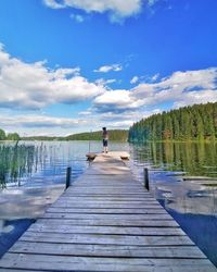 Pier amidst lake against sky