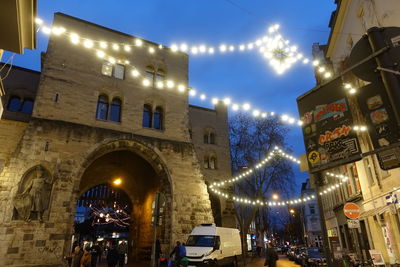 Low angle view of illuminated buildings in city at night