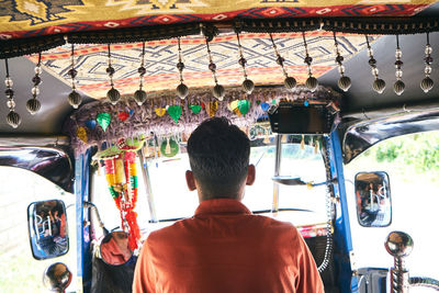 Rear view of man in bus