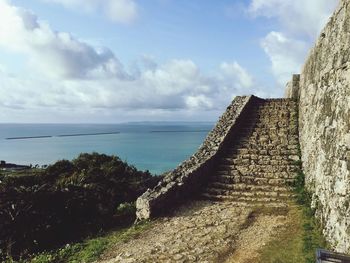 Scenic view of calm sea against cloudy sky