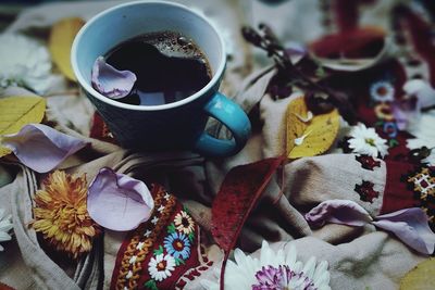 Close-up of coffee cup on fabric