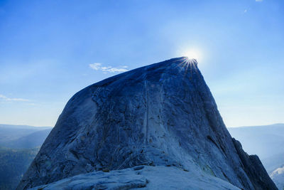 Scenic view of snowcapped mountains against blue sky