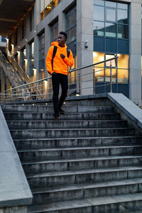 Full length of man standing on staircase