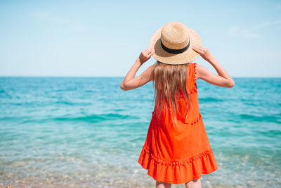 Rear view of woman standing on beach