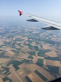 Cropped image of airplane flying over landscape