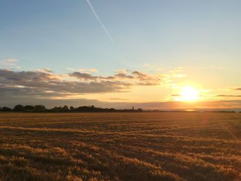 Scenic view of field against sky during sunset