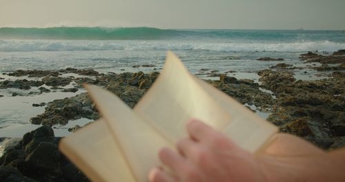 Cropped hand of woman holding umbrella
