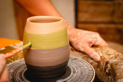 Cropped image of man making pottery at workshop
