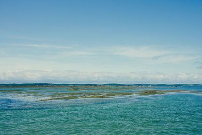 View of calm sea against blue sky