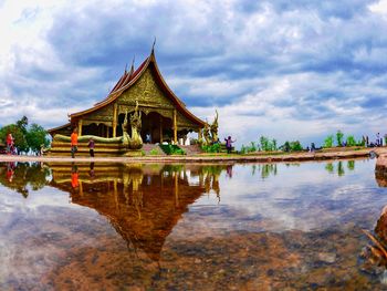 Panoramic view of lake and buildings against sky