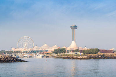 Ferris wheel in city against sky