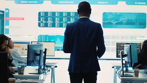 Rear view of man standing in cafe