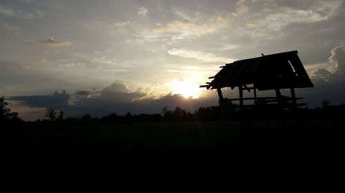 Low angle view of silhouette trees on landscape against sky