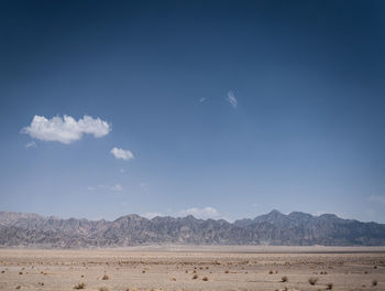 Scenic view of arid landscape against sky