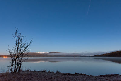 Scenic view of lake against blue sky