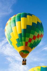 Low angle view of hot air balloons flying in sky