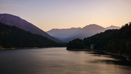 Scenic view of river and mountains against clear sky