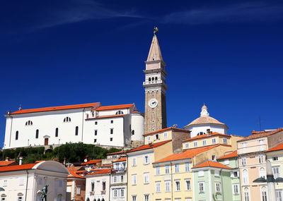 Low angle view of bell tower against blue sky