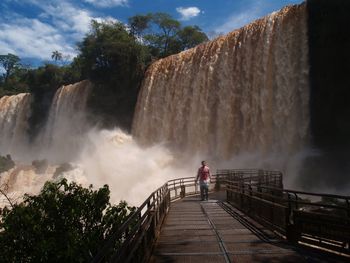 Scenic view of waterfall against sky