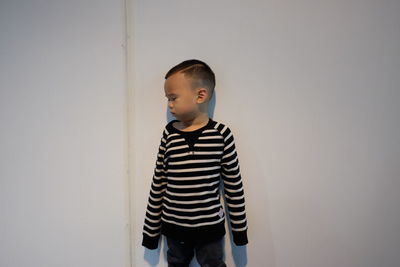 Boy standing against wall