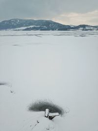 Scenic view of frozen lake against sky