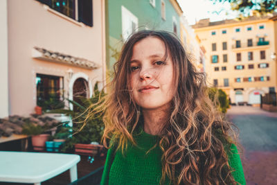 Portrait of woman against building